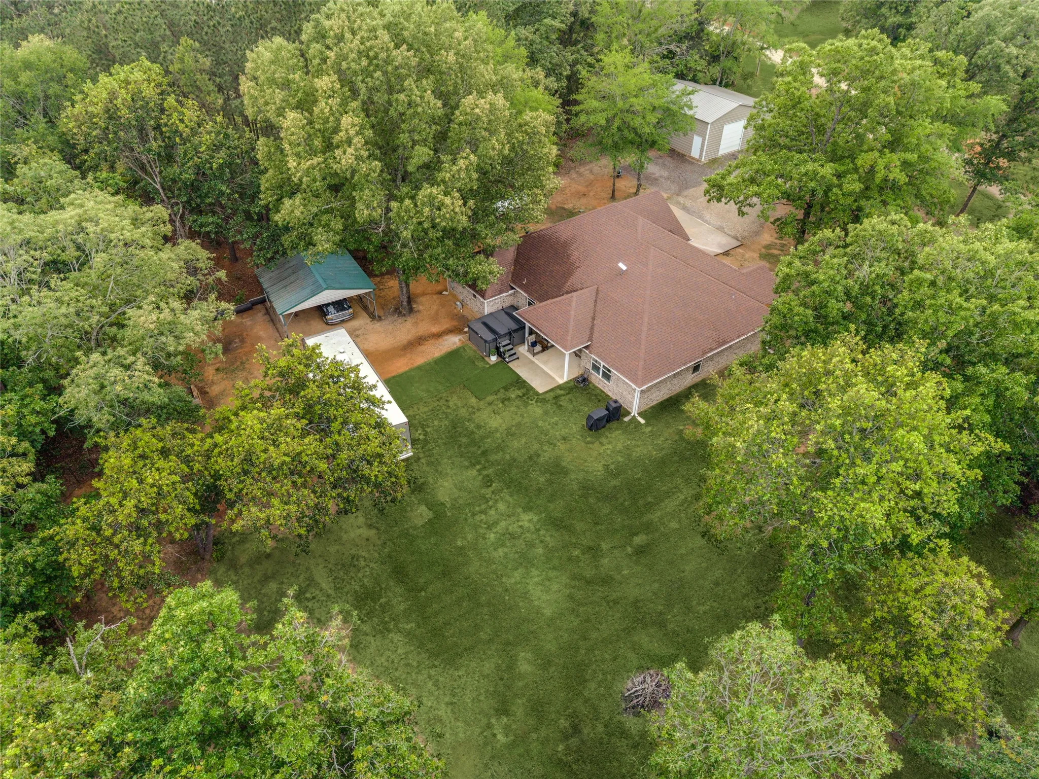 Aerial view of the back of the property. The property has a 50amp designated outlet for RV parking, as well as septic drop for the RV.