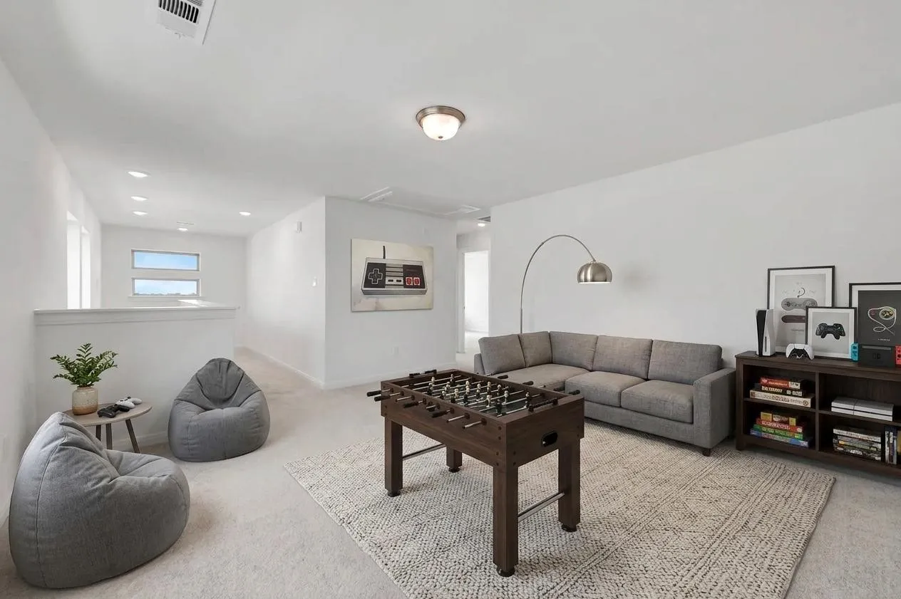 Carpeted upstairs landing with recessed lighting, a white half-wall, and horizontal window accents