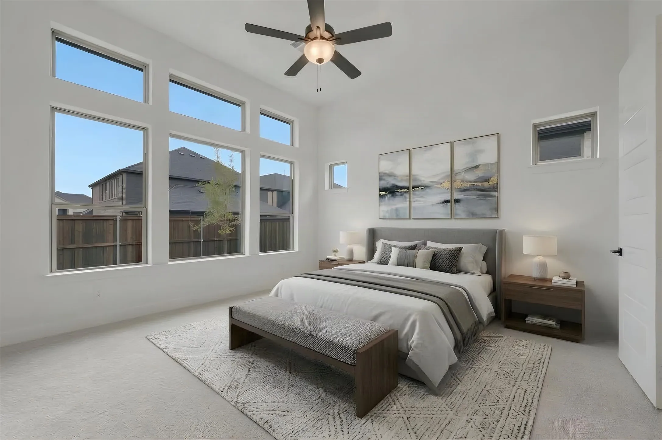 Room featuring high ceilings, multiple transom windows, an additional window, and a ceiling fan with integrated lighting