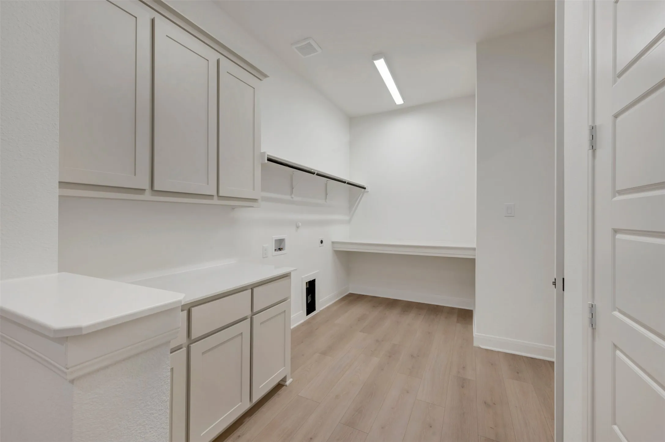 White shaker-style cabinetry with integrated countertops