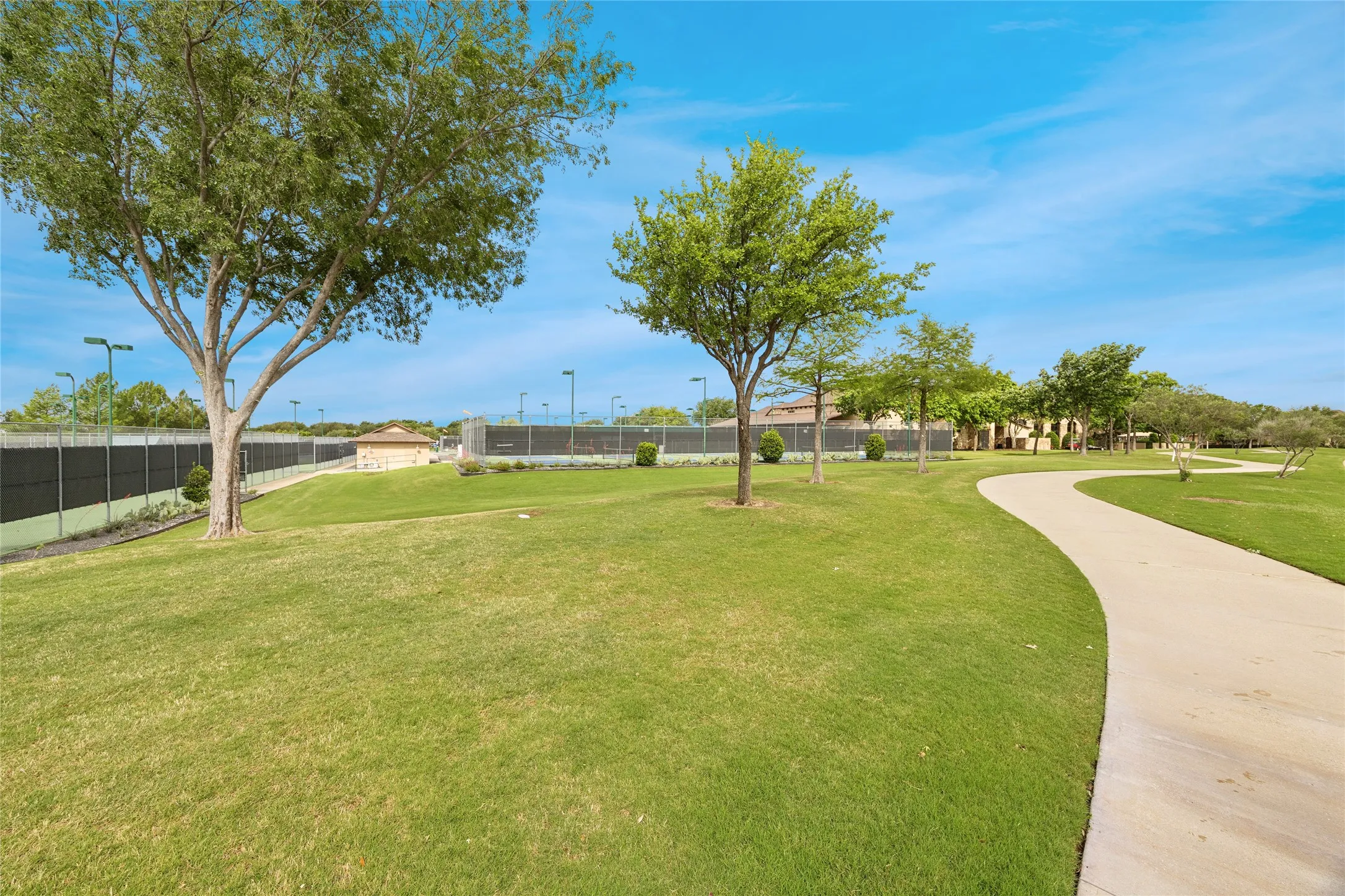 Walking path by tennis court