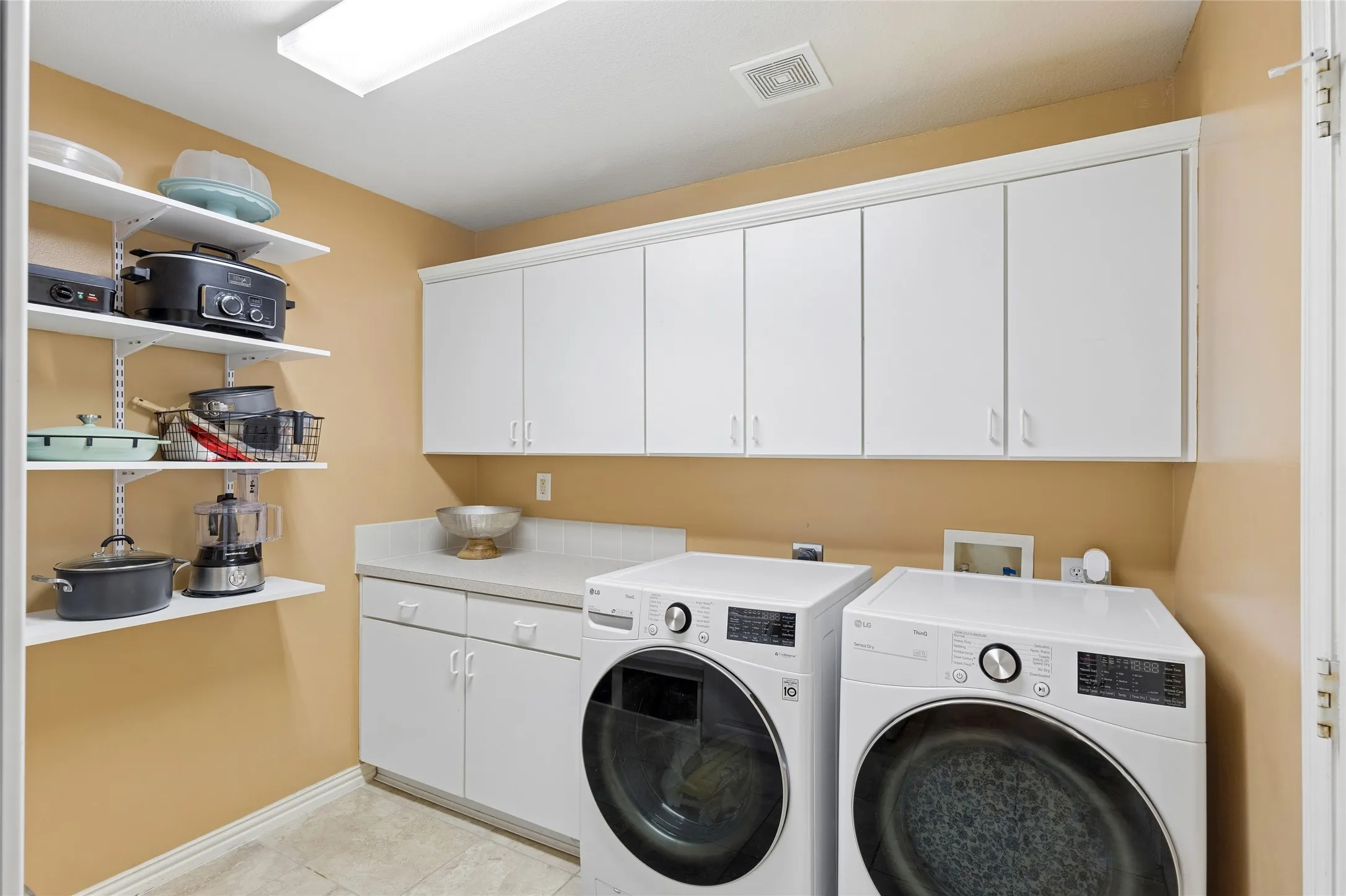 Roomy laundry room with built-in cabinets