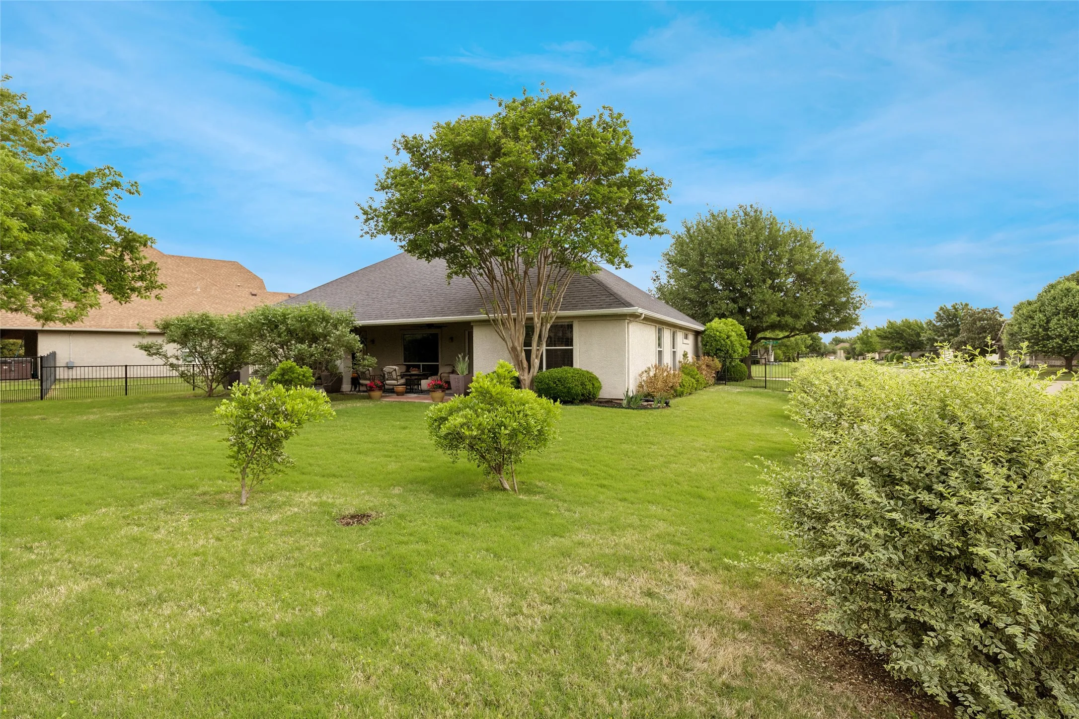 View of home from landscaped backyard