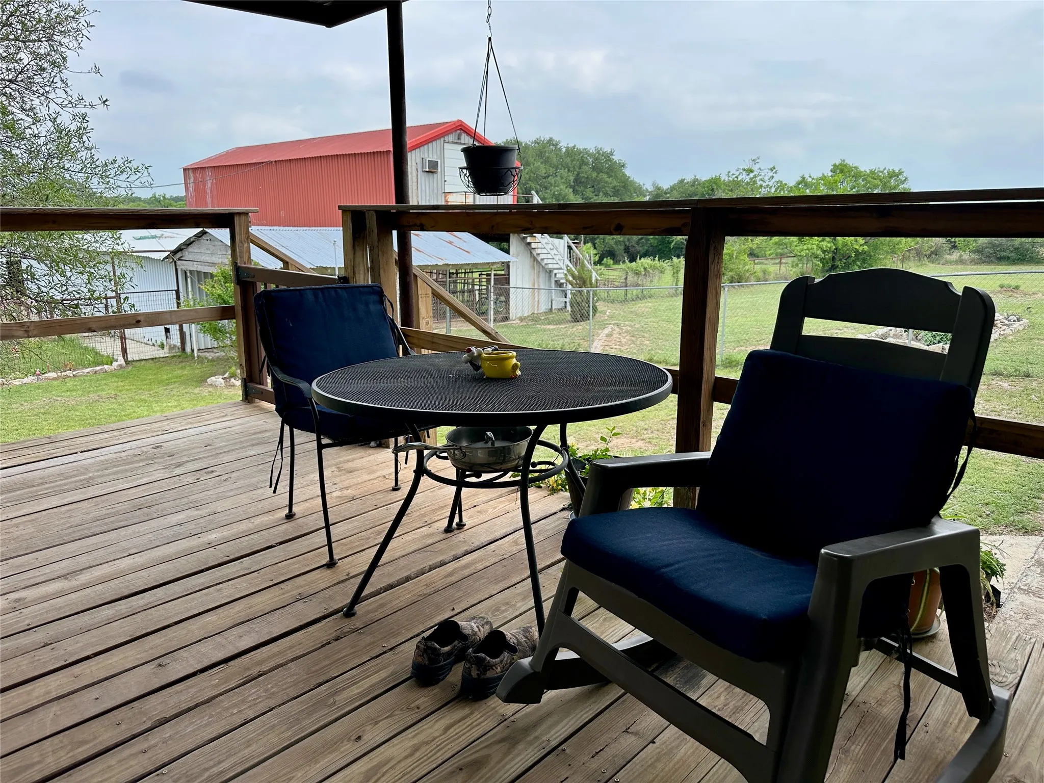 Covered outdoor deck featuring natural wood flooring and railing