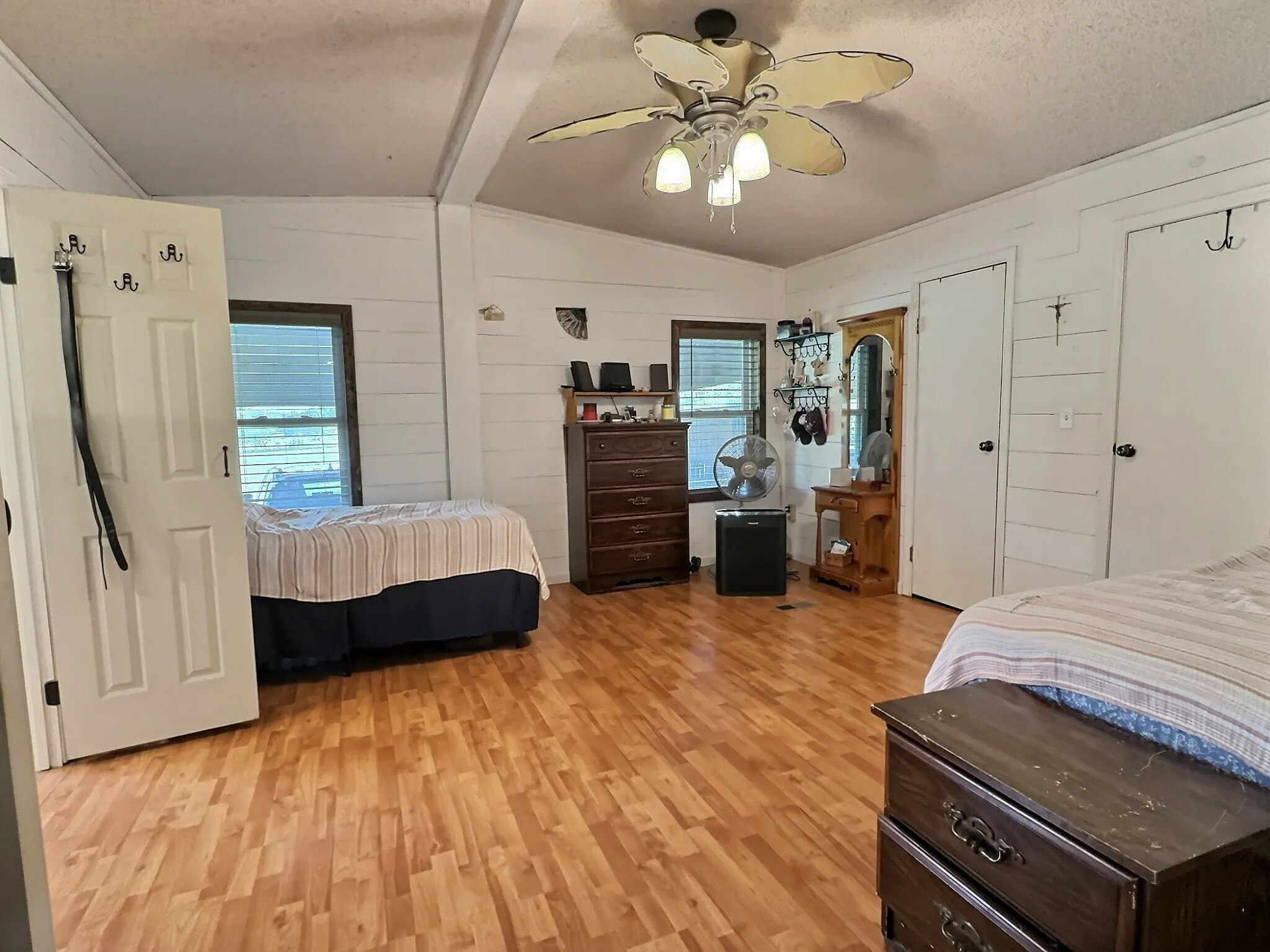 Interior space featuring light wood-finish flooring and white shiplap-style walls
