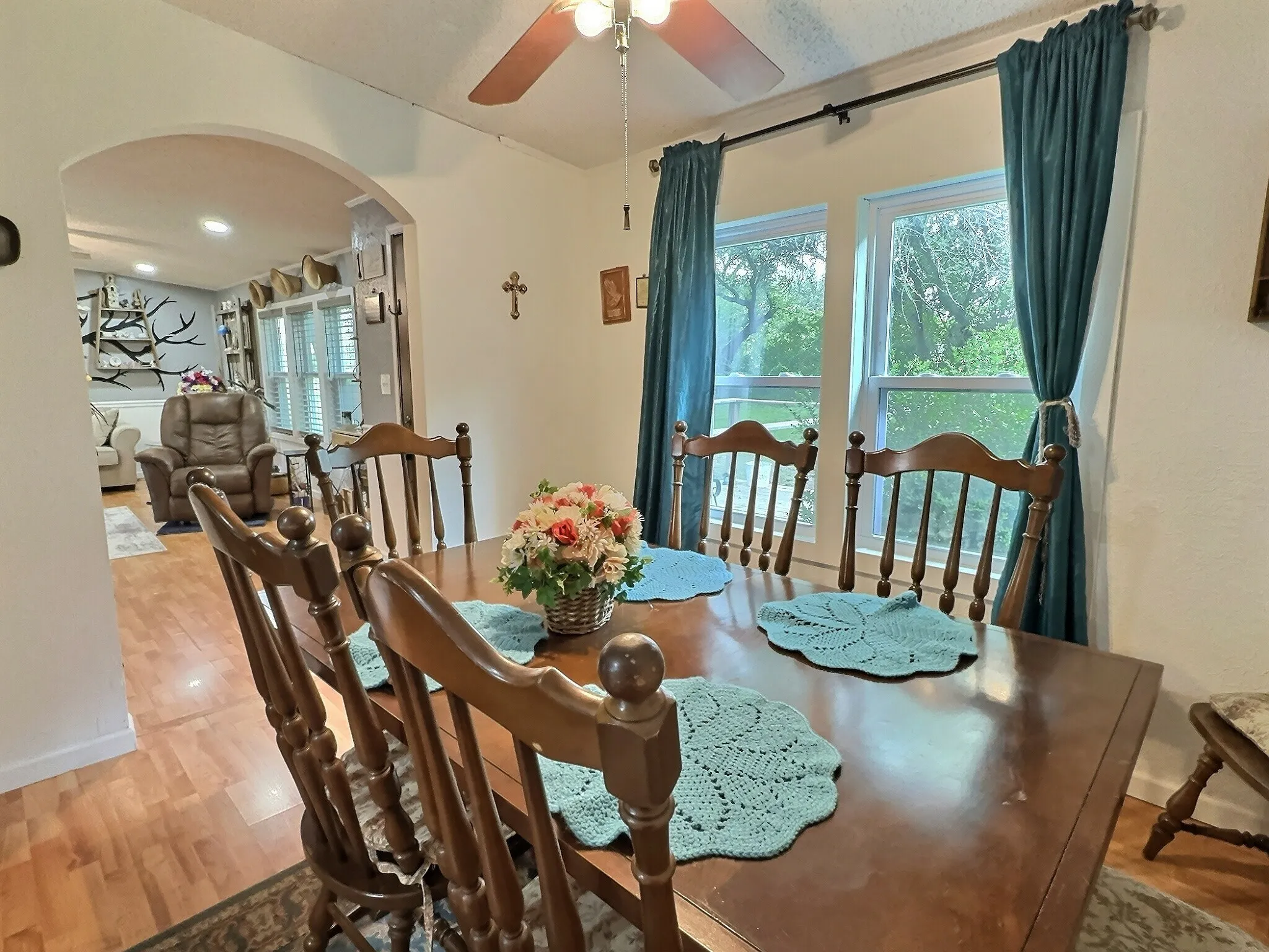 Dining area featuring wood-finish flooring and an arched doorway