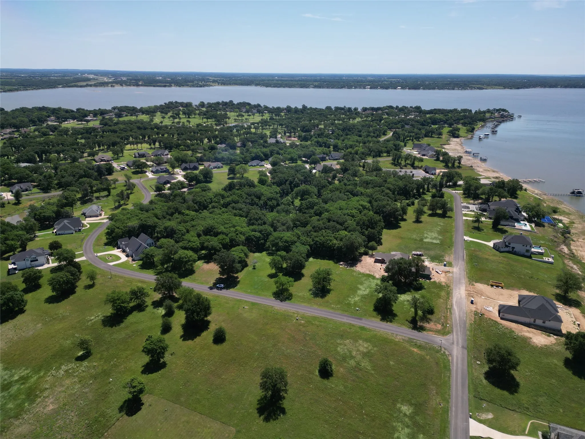 Expansive aerial perspective showcasing a significant body of water bordered by a treed landscape