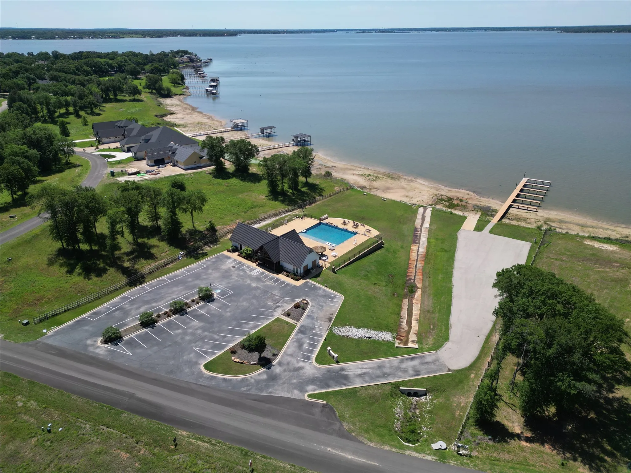 Expansive waterfront property featuring a large lake, multiple boat docks, and a private boat launch