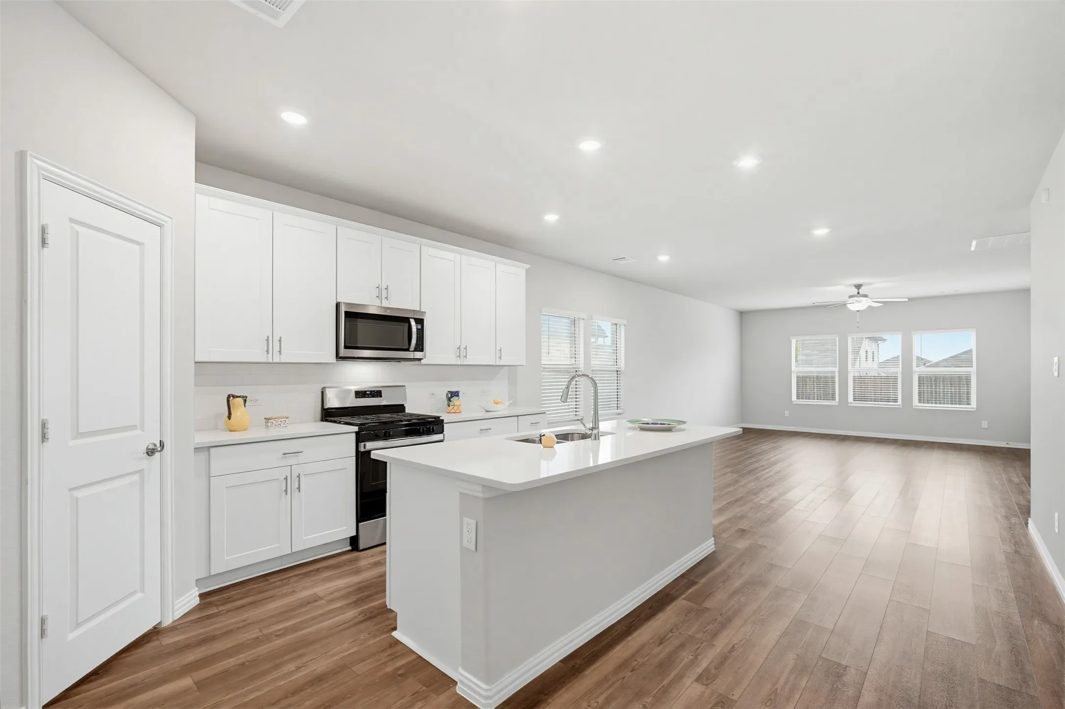Modern kitchen with open layout overlooking the living and dining areas, ideal for hosting and staying connected.