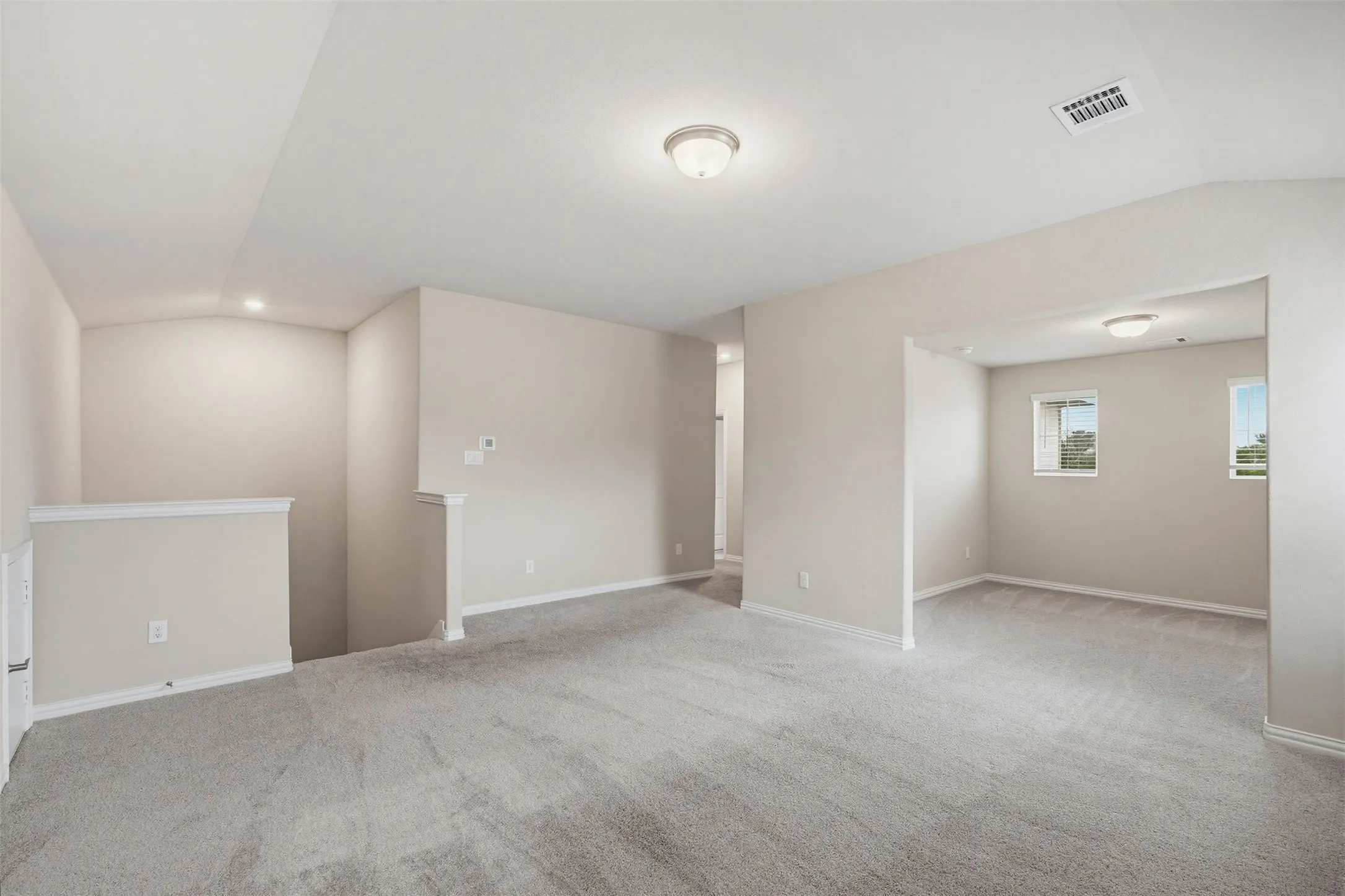 Spacious upstairs game room offering flexible space for entertainment, play, or a second living area.