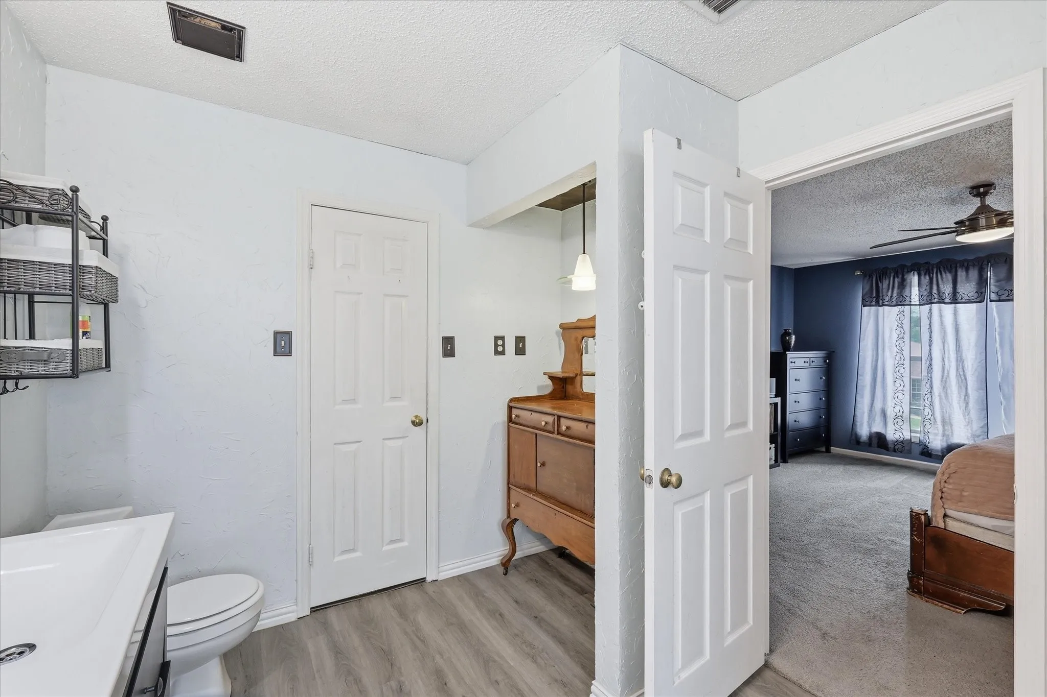 Bathroom featuring a walk-in shower with subway tile surround, a built-in bathtub with subway tile wainscoting, and a vanity with an integrated sink