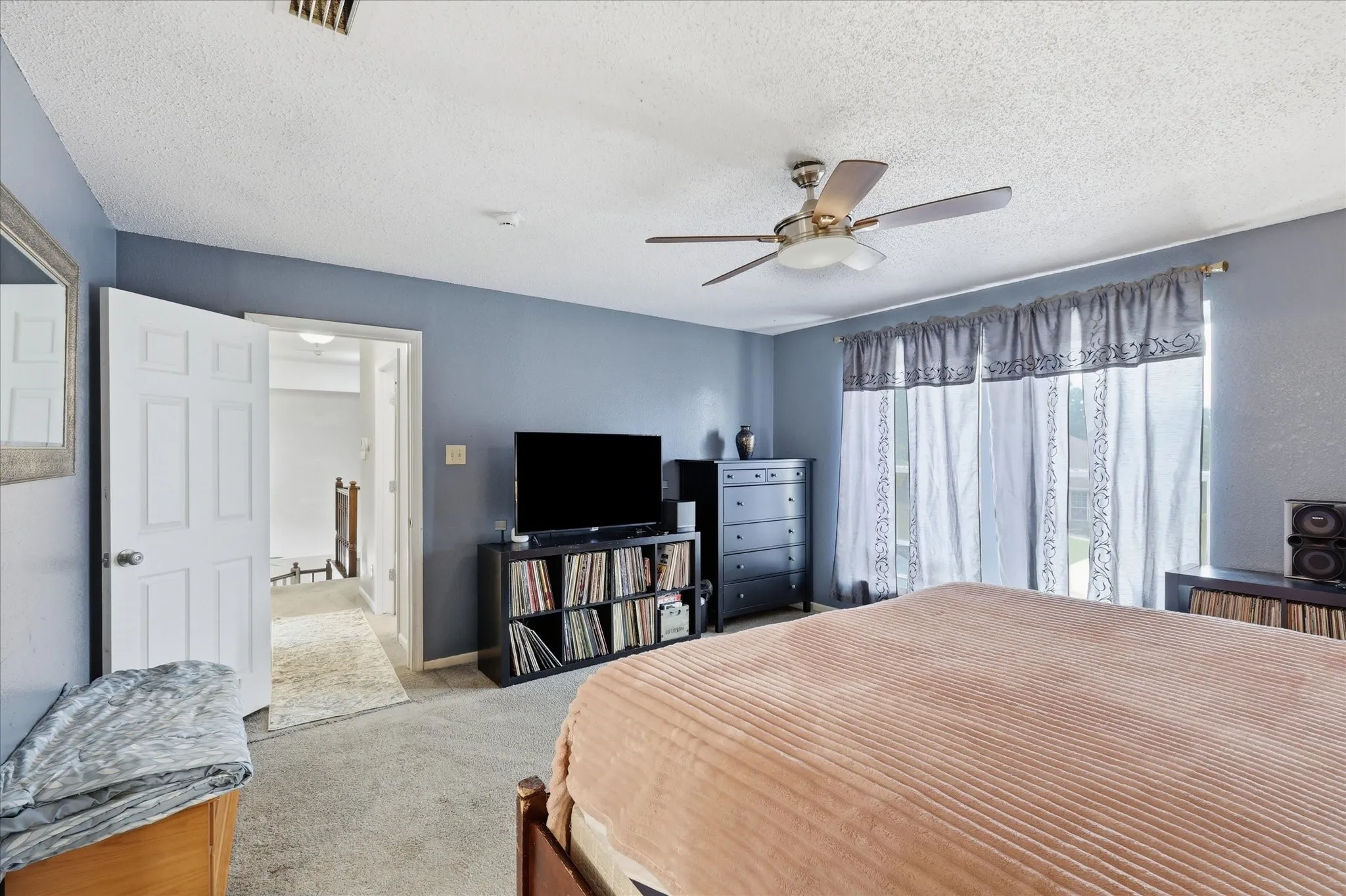 Bedroom featuring light blue walls and carpeted flooring