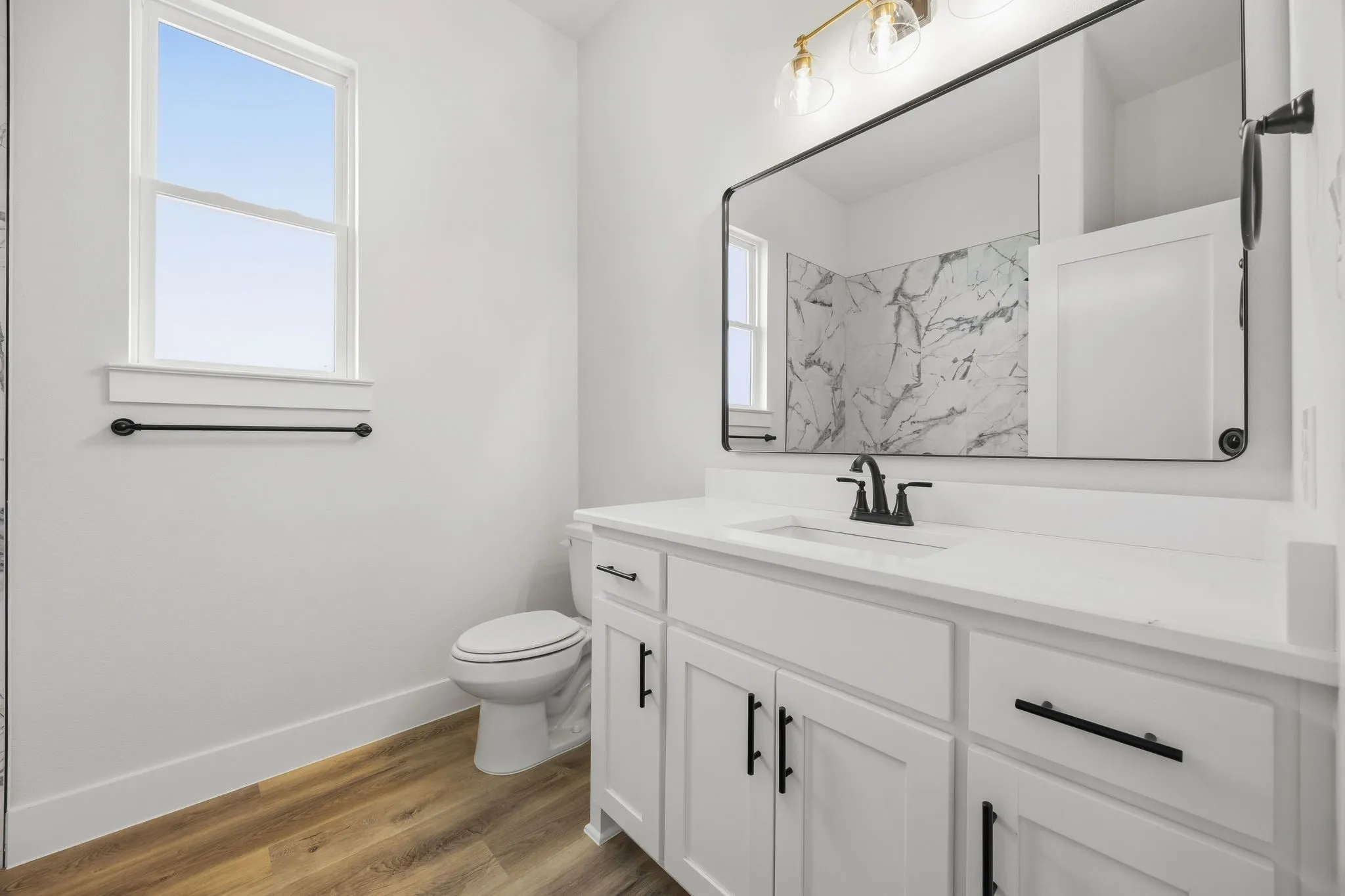 White shaker-style vanity with a white countertop and rectangular undermount sink