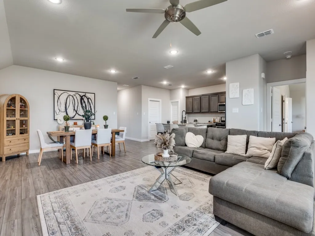 Open concept living and dining area featuring wood-finish flooring, recessed lighting, and a ceiling fan