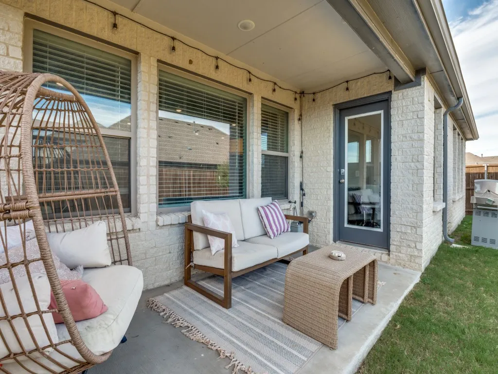 Covered patio featuring a concrete slab and string lighting