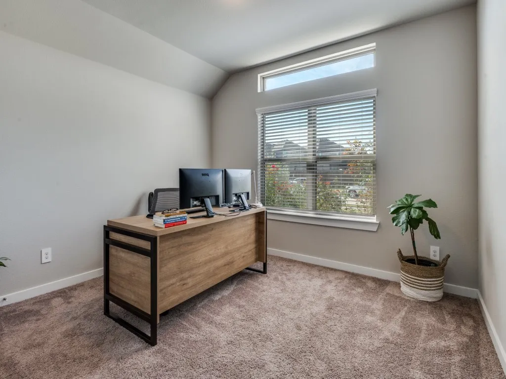 Light-filled interior space featuring a large window with blinds and an additional transom window