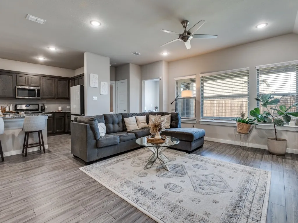 Wood-finish flooring extending throughout the open concept living area and kitchen