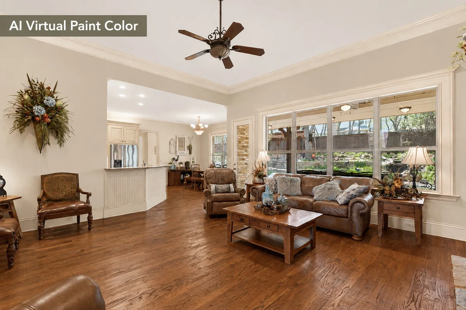 Spacious living area featuring wood-finish flooring, a ceiling fan, and extensive crown molding