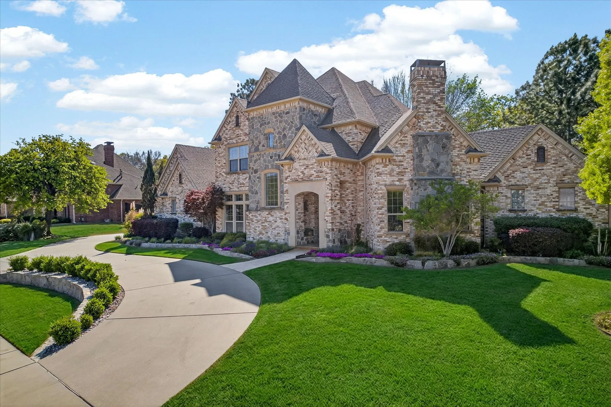 Stone and brick exterior with a multi-gabled roofline