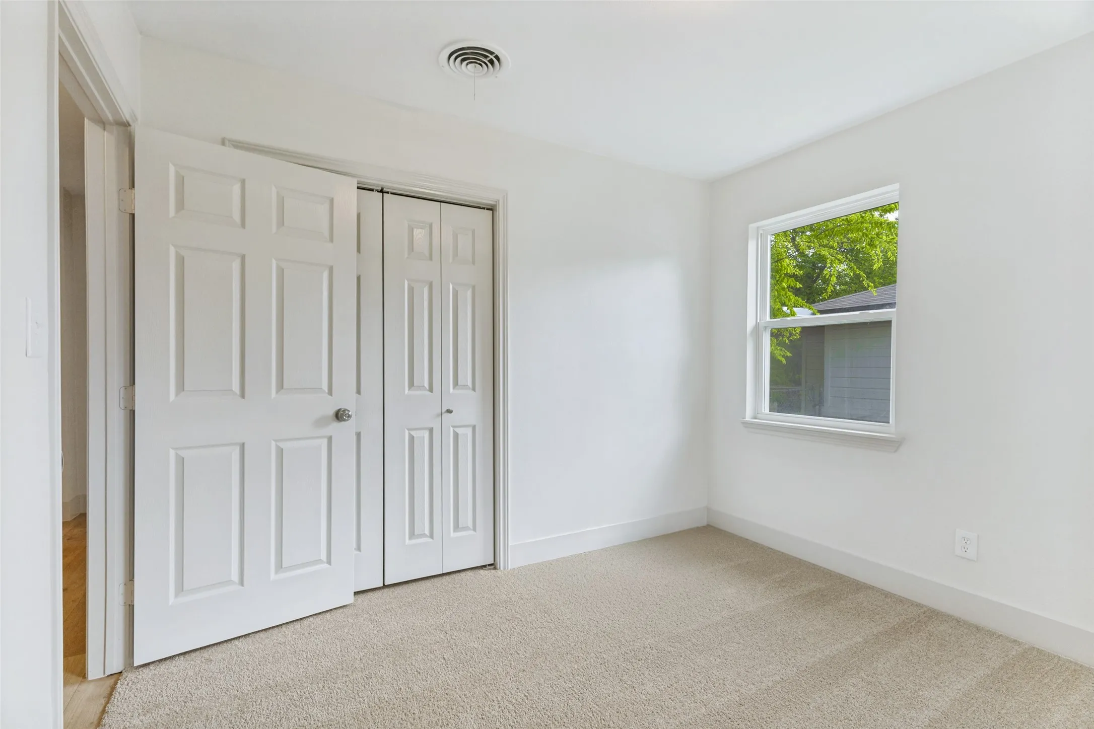 Neutral wall paint and carpeting throughout