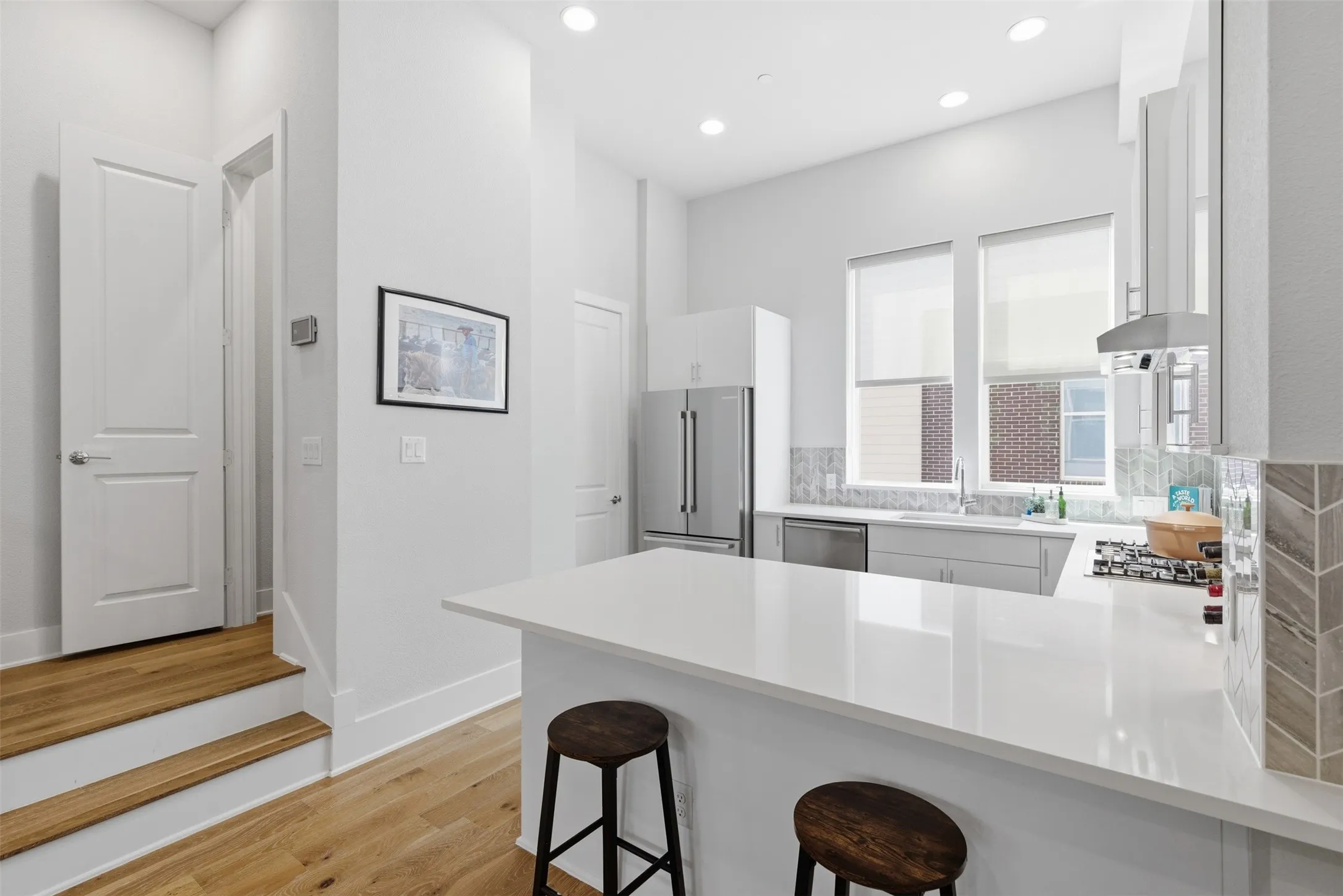 2nd floor: Half bath to the left. Kitchen has large windows.