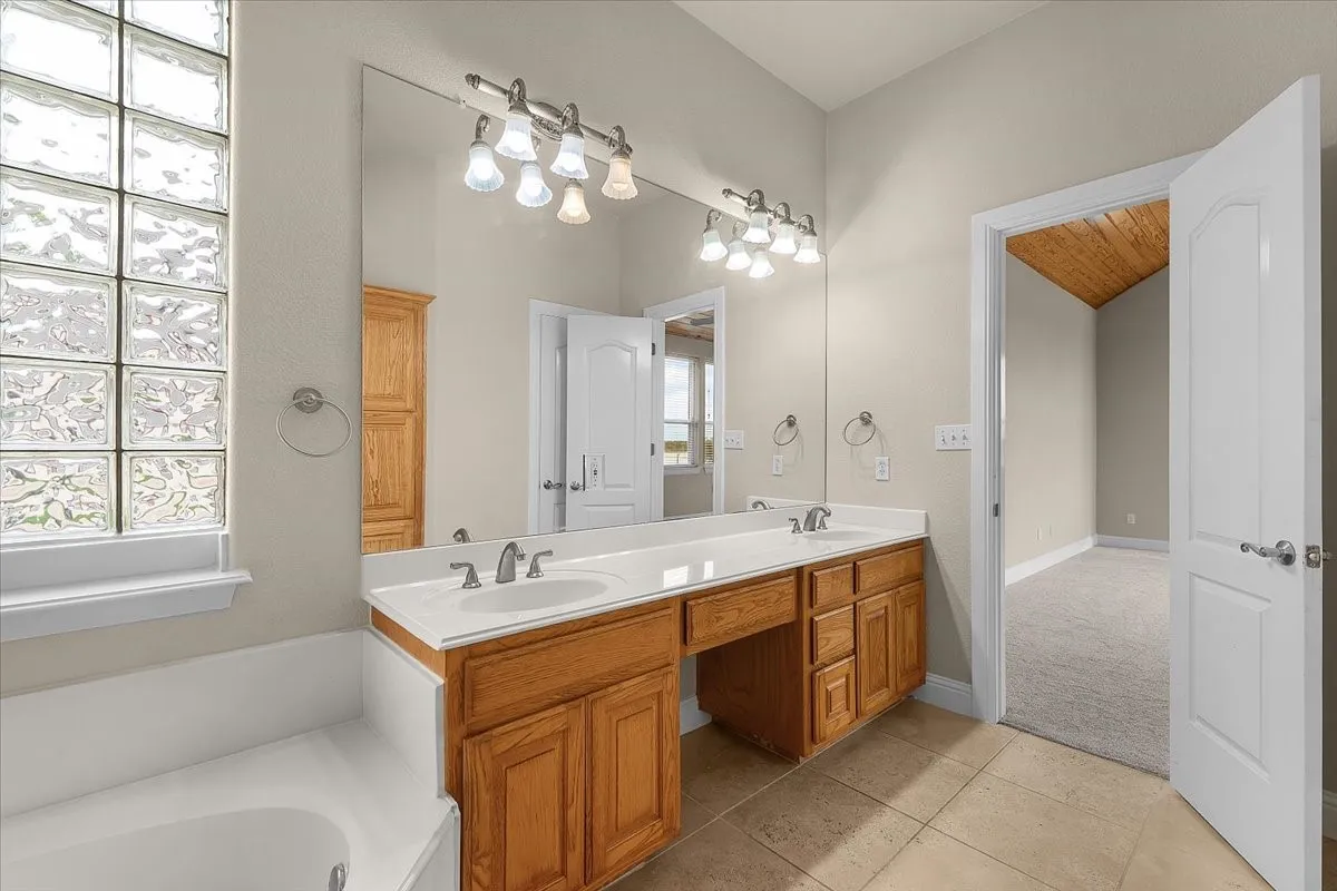 Double vanity with integrated sinks and wood cabinetry