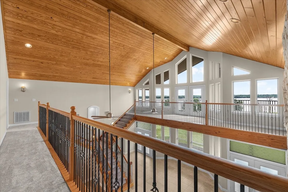 Vaulted wood-plank ceiling with recessed lighting and a ceiling fan