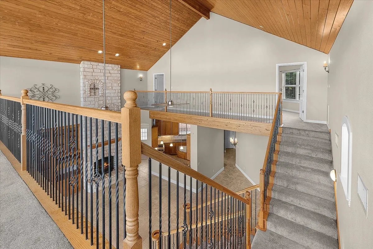 Vaulted ceiling with wood-finish planks and recessed lighting