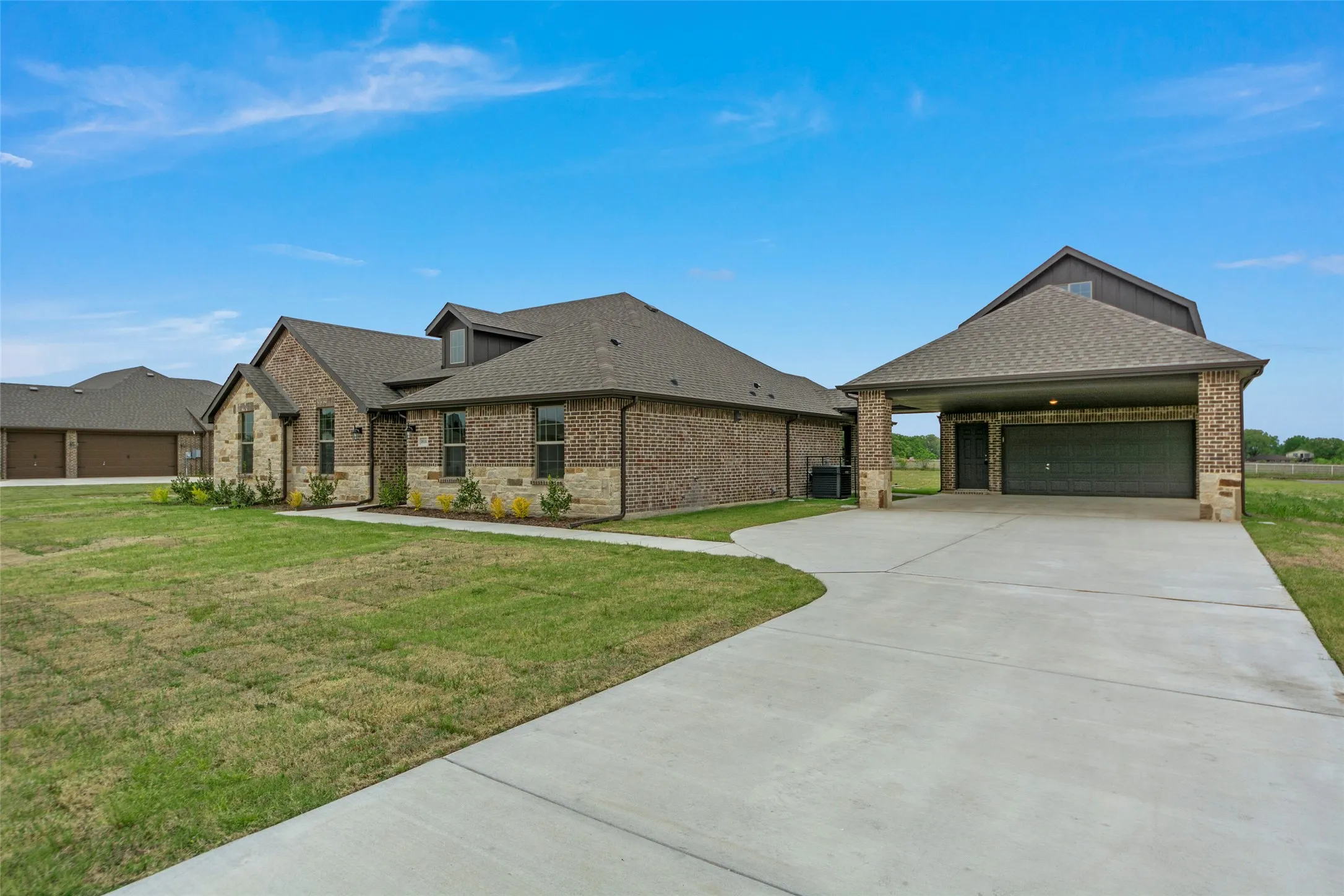 Brick exterior with stone accents, a gabled roofline, and dormer windows