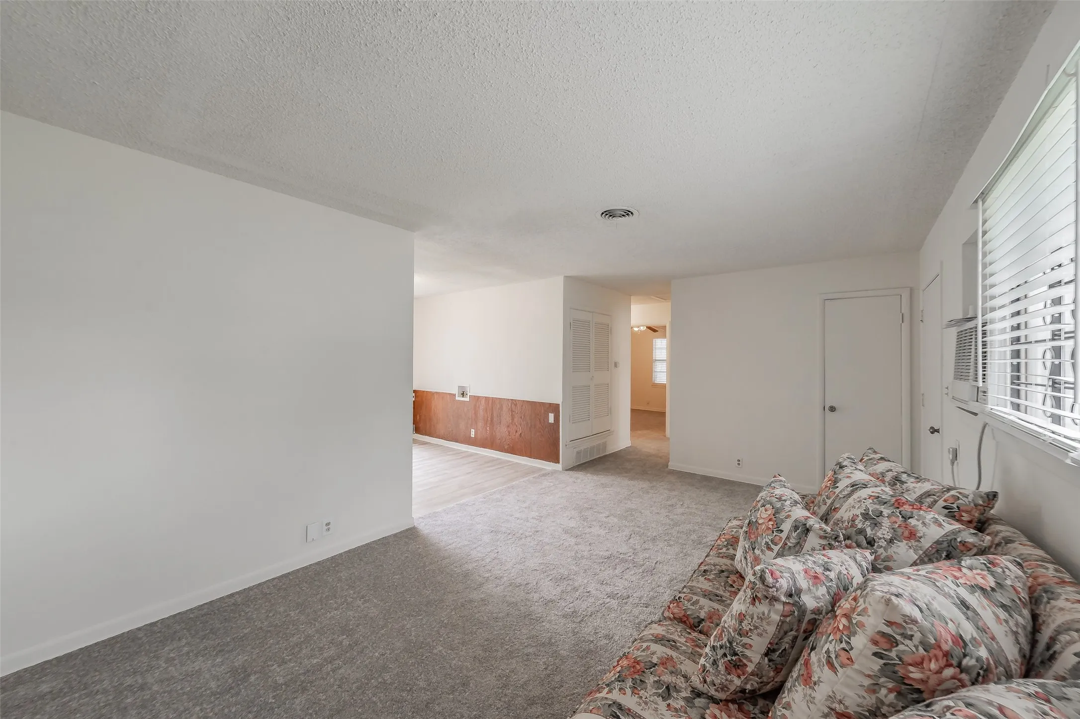 Living area featuring light gray carpeting and white painted walls