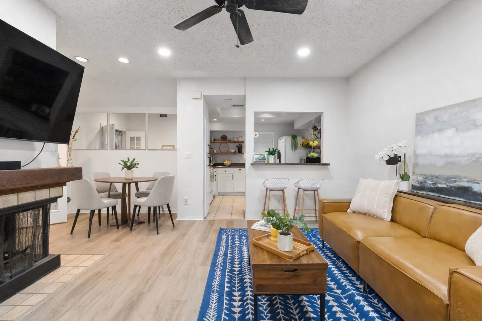 cozy wood burning fireplace centrally located between living and dining spaces