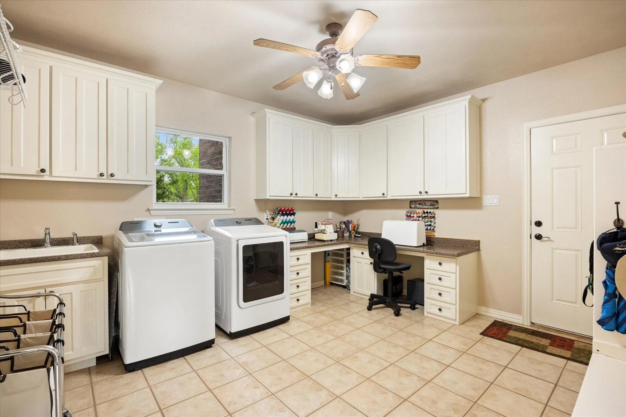 Laundry room is large enough to share space for your favorite hobby, such as sewing, scrapbooking or crafting.