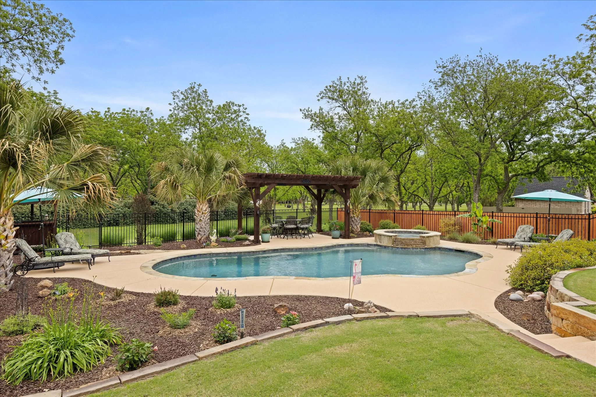 Enjoy this private oasis with pool and spa surrounded by pecan trees.