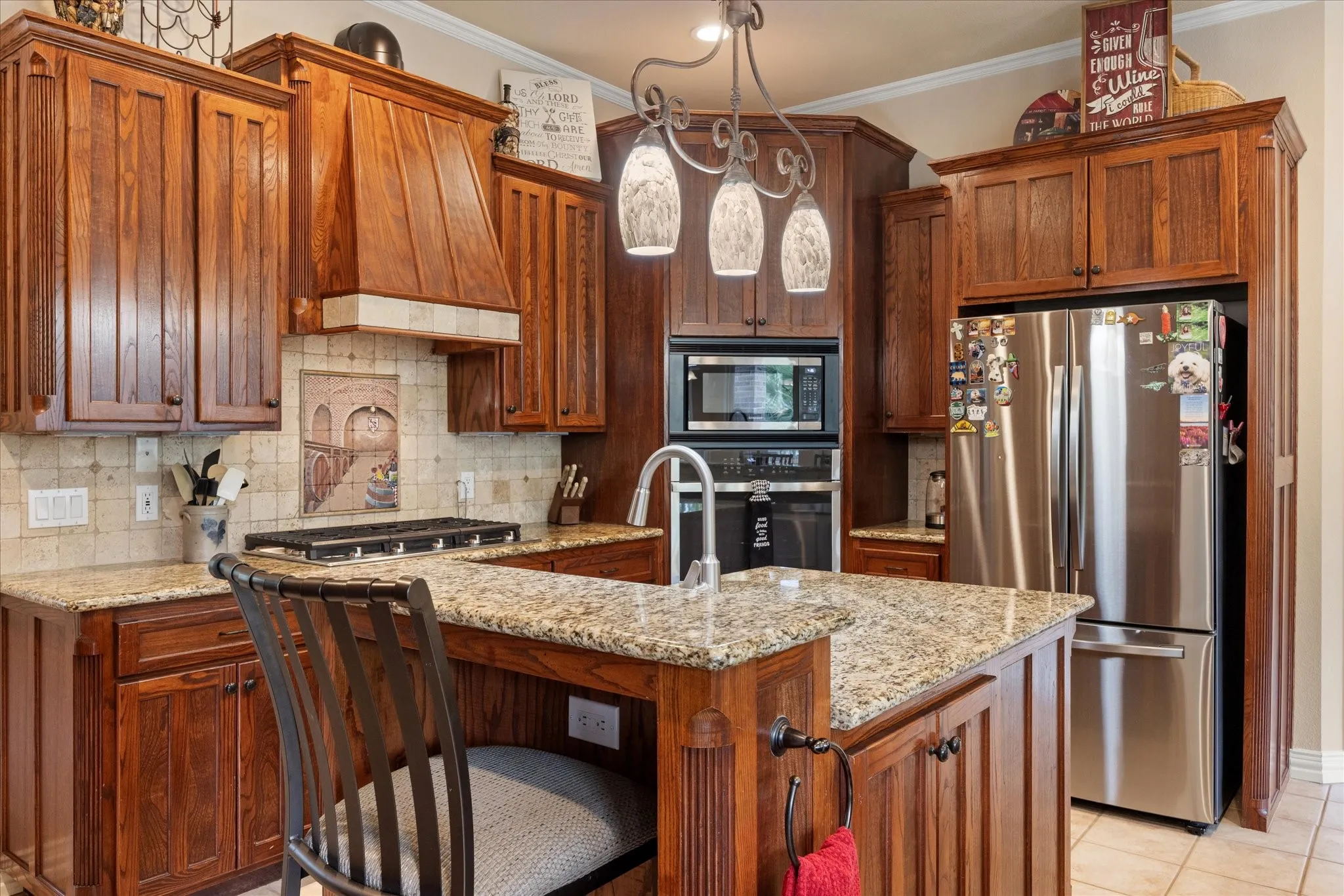 The kitchen boasts rich cabinets, granite countertops and stainless steel appliances.