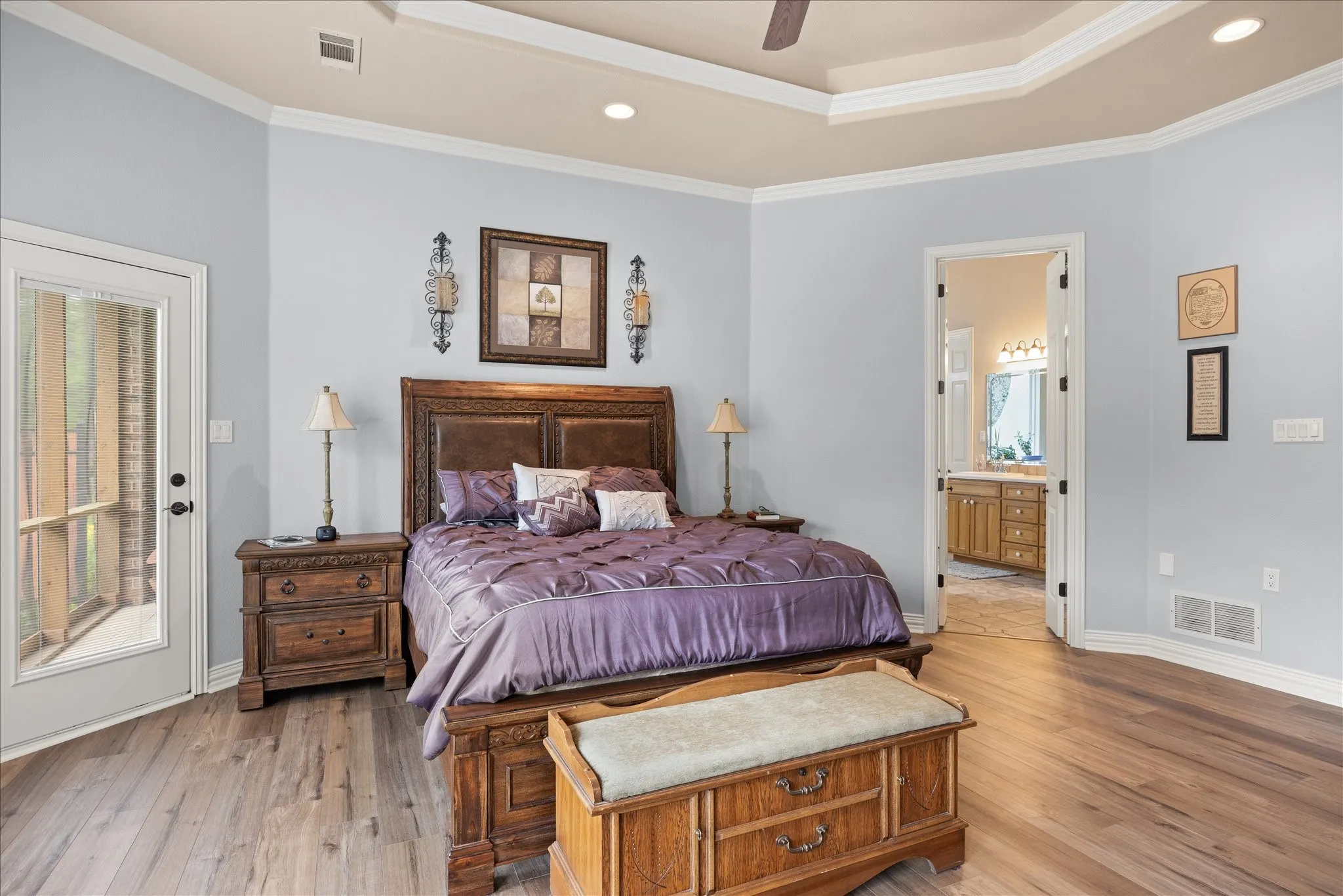 The primary bedroom has beautiful luxury vinyl plank floors and tray ceilings.
