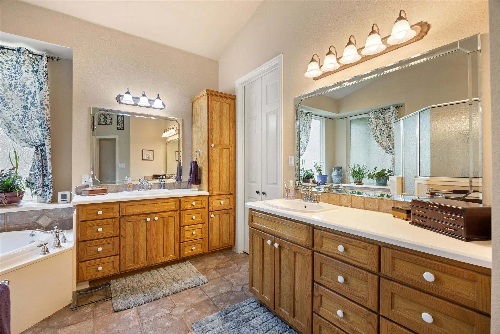 Primary bathroom features double vanity and large walk-in closet.