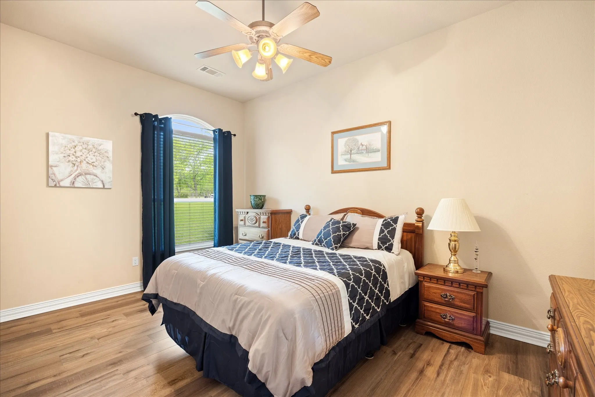 Second bedroom downstairs has luxury vinyl plank floors and neutral colors.