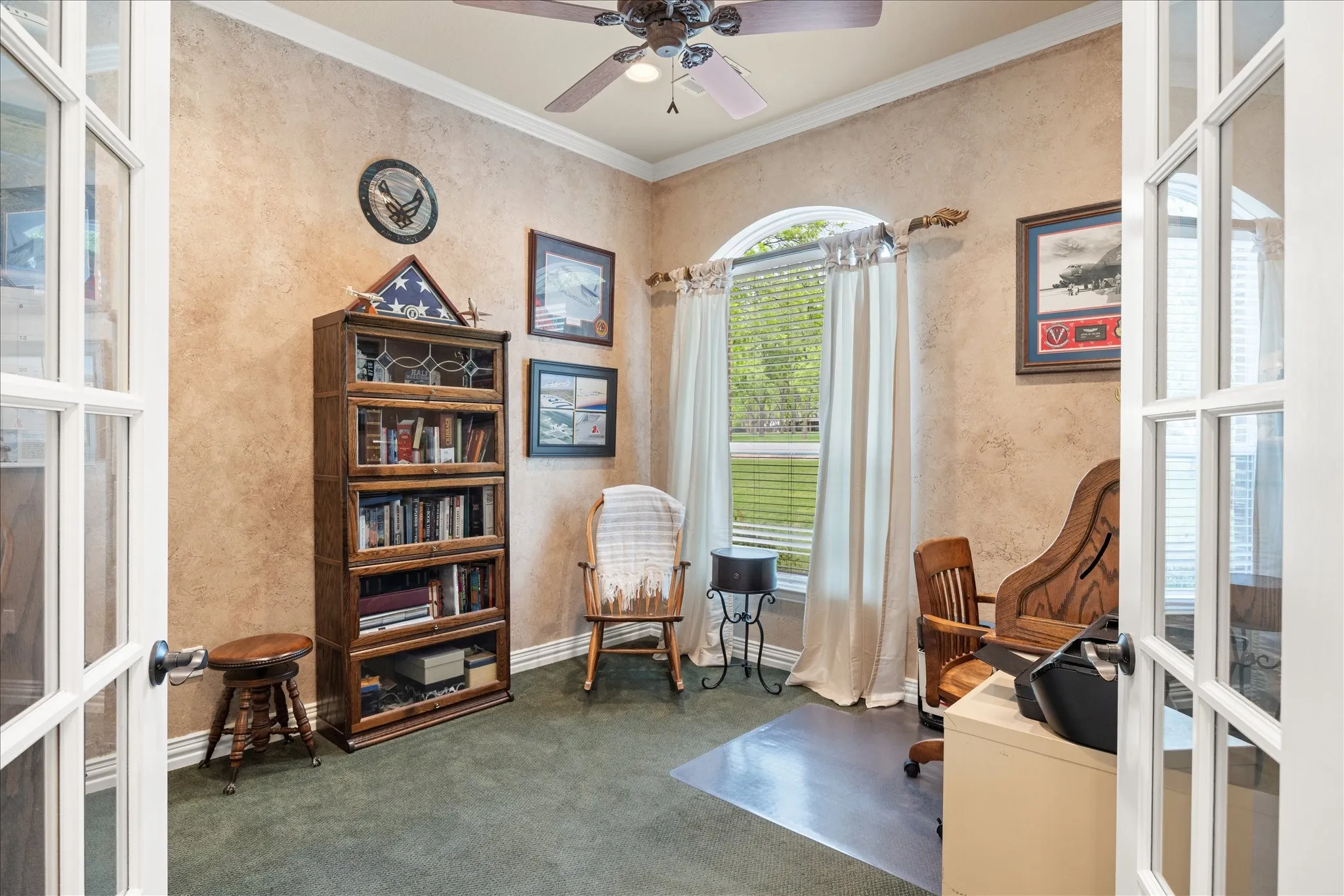 The office is located at the front of the home and offers privacy with French doors.