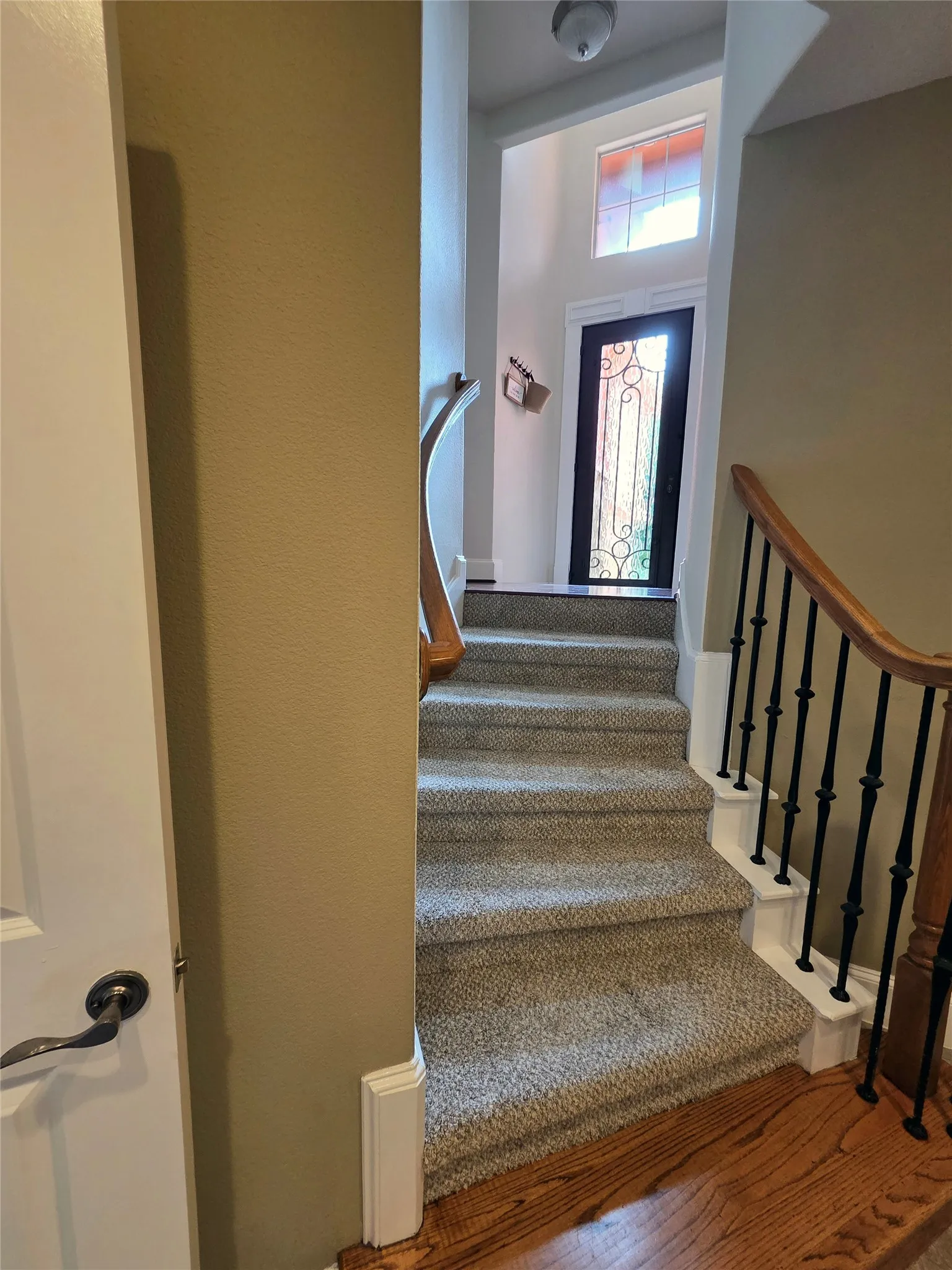 stairway from first floor mudroom up to entry way (entry located between 1st and 2nd floor) and up to 2nd level