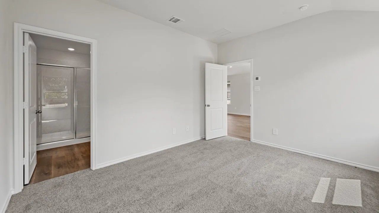 Spacious room featuring light gray carpeting and white painted walls