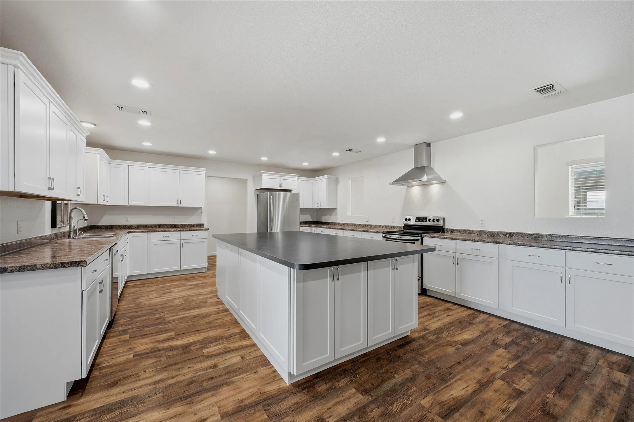 Residence kitchen has a large island, extensive counter top space and all stainless appliances