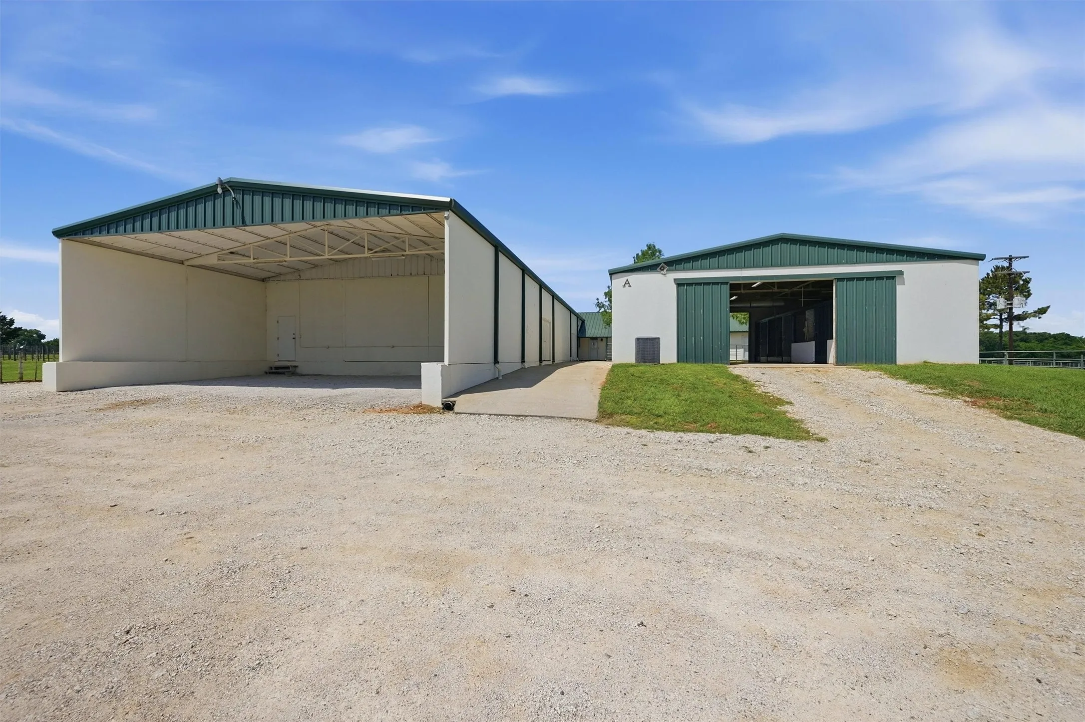 Adjacent 39' x 24' covered storage area next to the 5-stall​​‌​​​​‌​​‌‌​‌‌​​​‌‌​‌​‌​‌​​​‌​​ barn