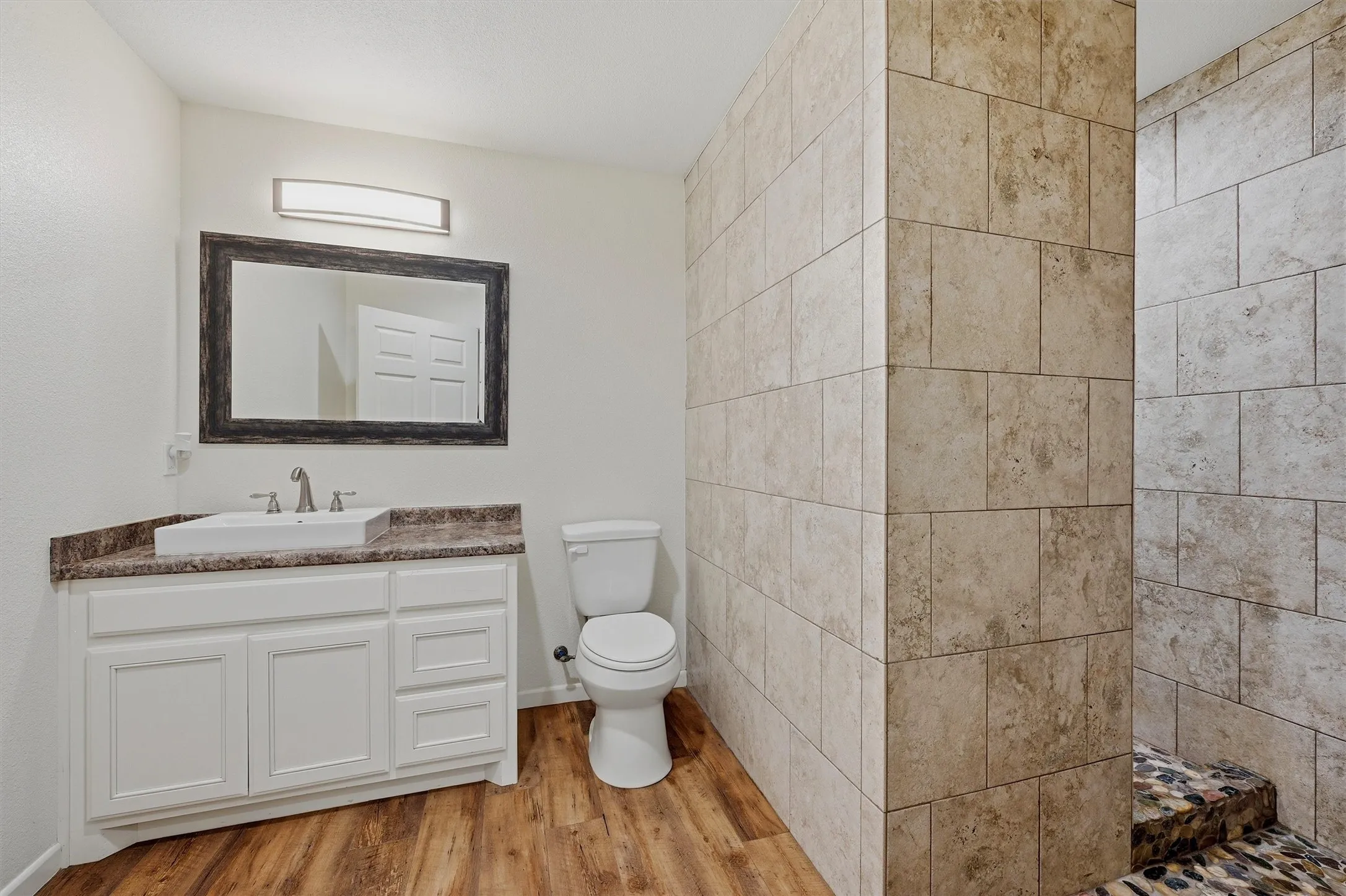 Second bathroom with stand-alone shower, vanity and toiler