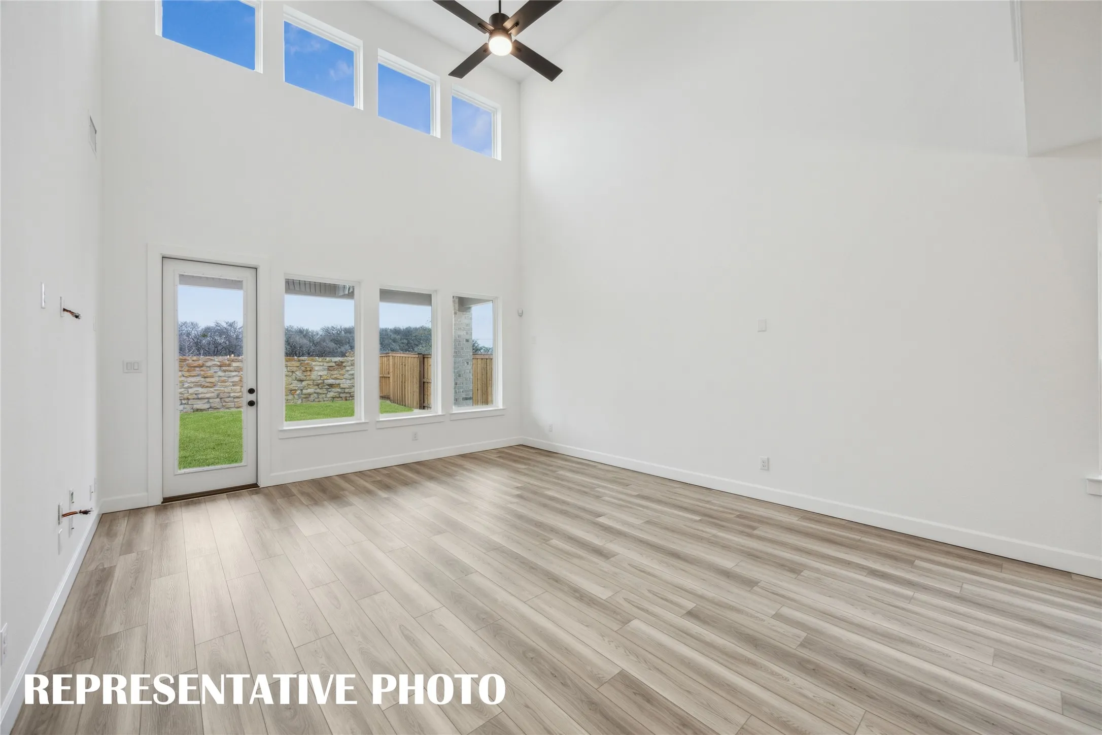 Light filled and inviting, this spacious family room is the perfect place for you to host family gatherings.  REPRESENTATIVE PHOTO