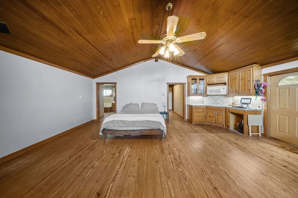 This property features vaulted wood panel ceilings and hardwood floors