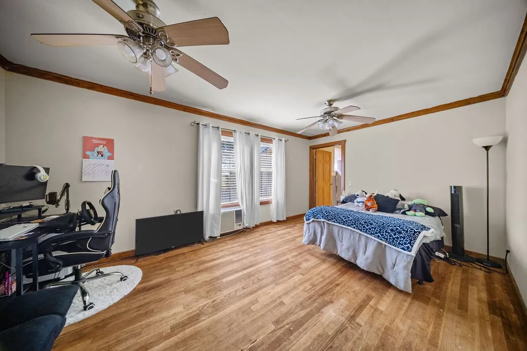 The room features polished wood flooring, light-colored walls, and detailed wood trim