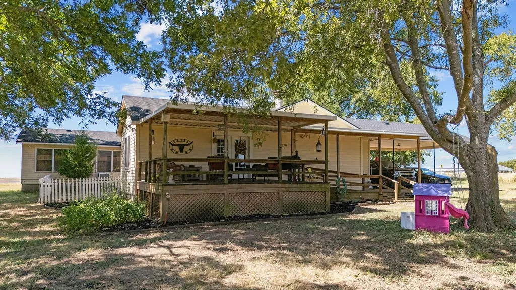 The property features an expansive covered deck, providing ample space for outdoor enjoyment
