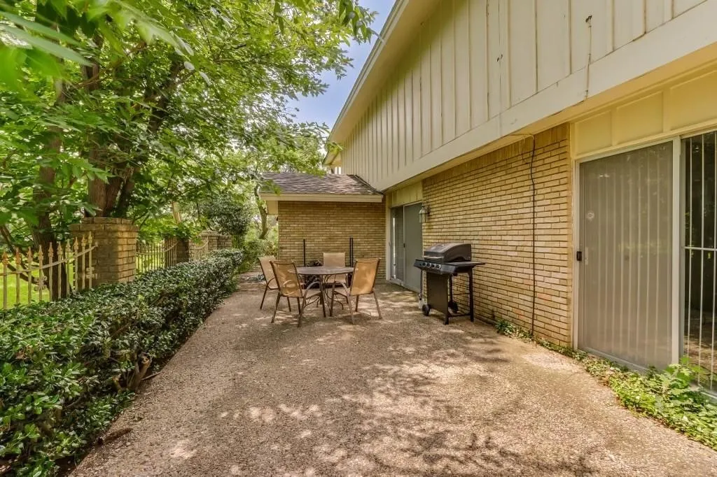 Expansive outdoor patio area featuring a textured aggregate surface