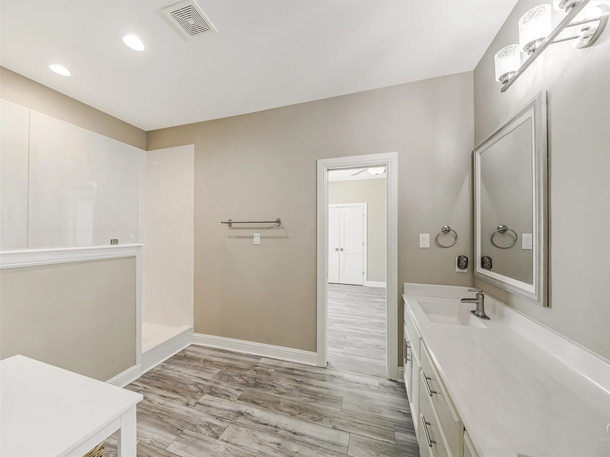 Large Jack-n-Jill style bathroom leaves everyone with plenty of space and fantastic lighting with luxurious walk in shower.