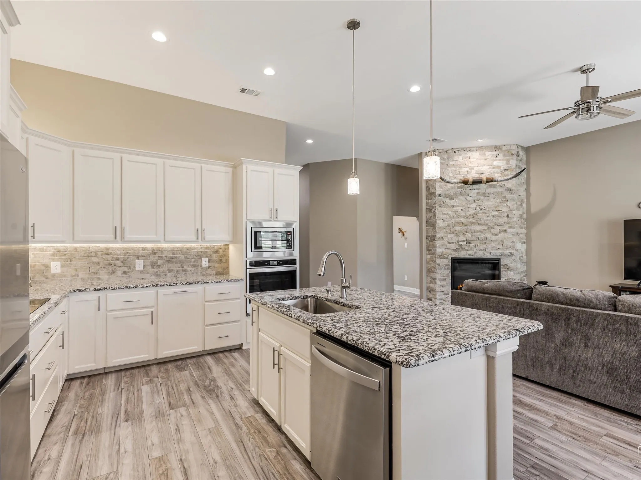 Large island and built in appliances make for a sleek aesthetic and perfect work flow in the kitchen